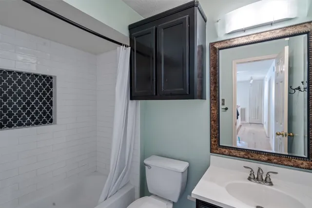 a bathroom with a toilet sink and shower