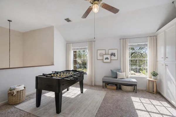 a living room with furniture a window and a potted plant