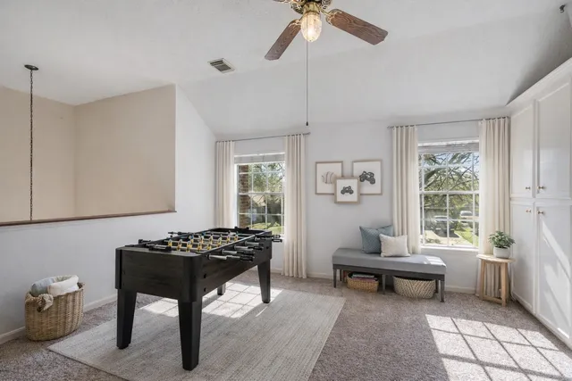 a living room with furniture a window and a potted plant