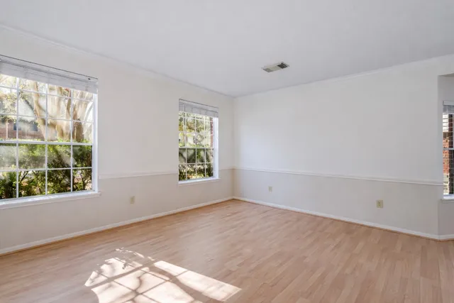 wooden floor in an empty room with a window