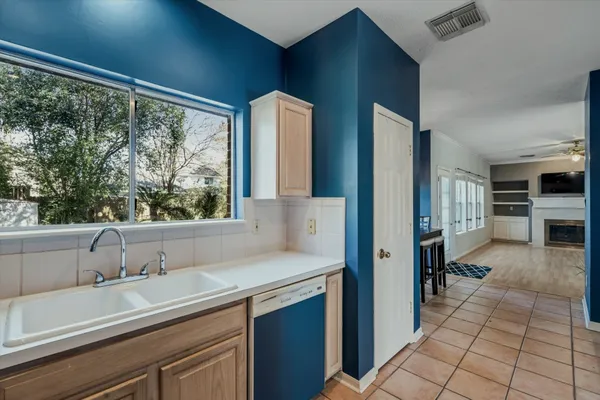 a kitchen with a sink and large window