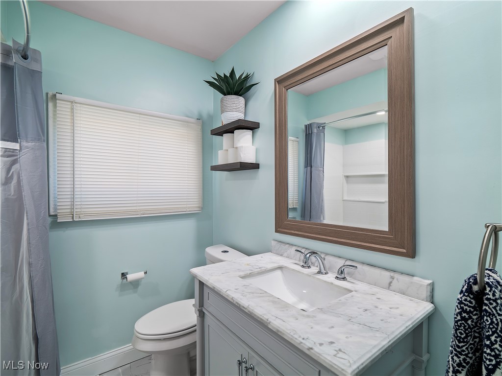 6377 Fairhaven Road Cleveland, OH 44124 - Photo 24 of 33 Bathroom featuring vanity, toilet, and baseboard heating
