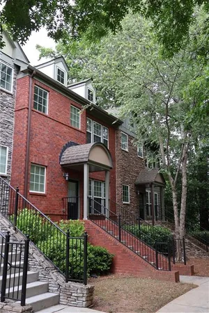 front view of a brick house with a small yard
