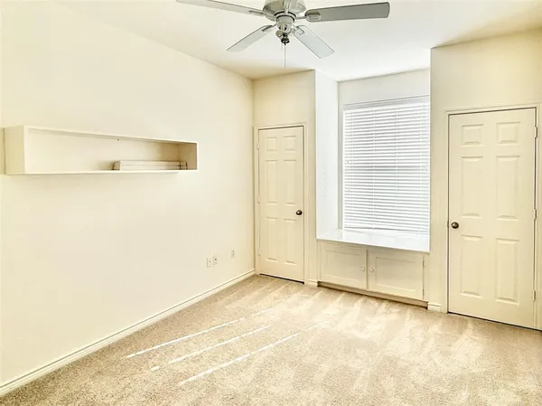an empty room with a ceiling fan