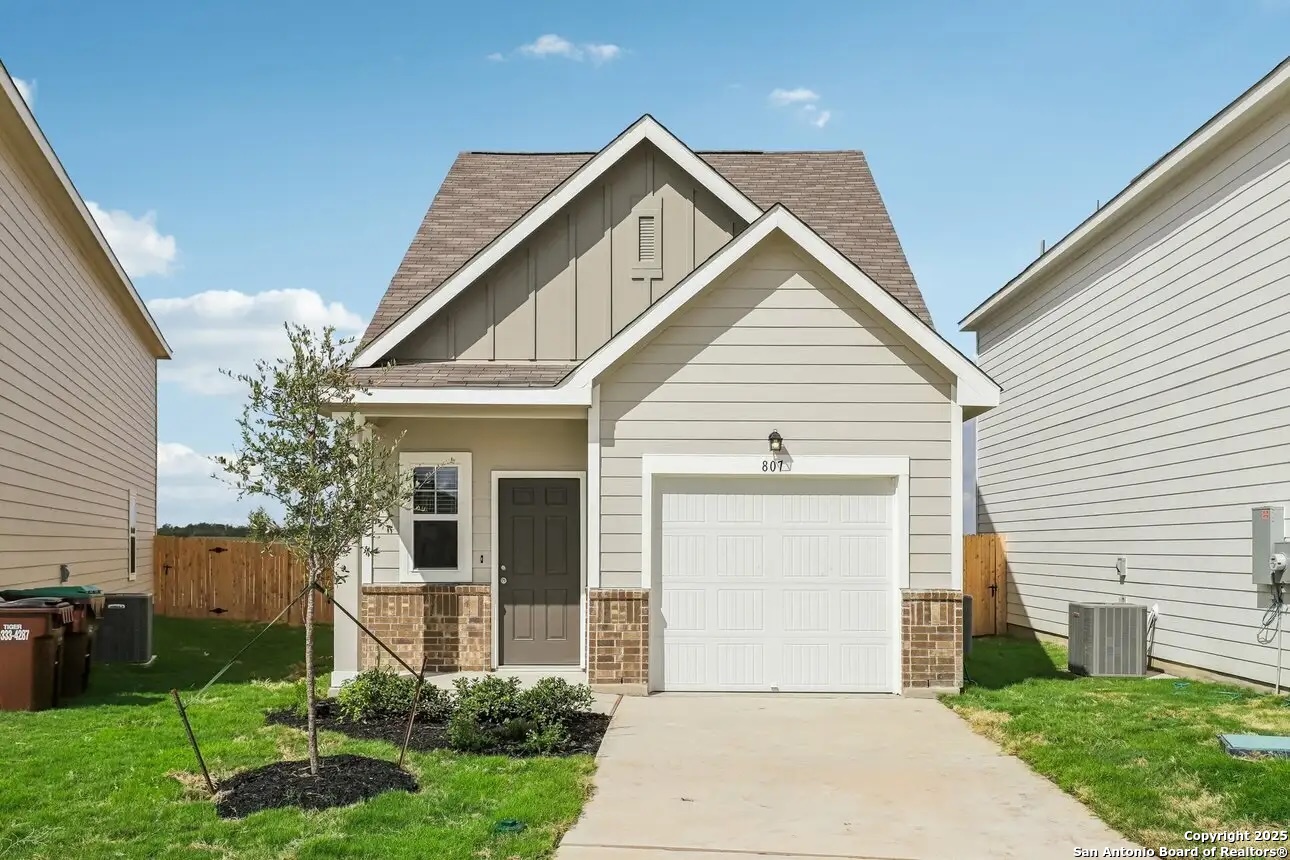 815 Dark Lark Adkins, TX 78101 - Photo 2 of 11 a front view of a house with a garden and plants