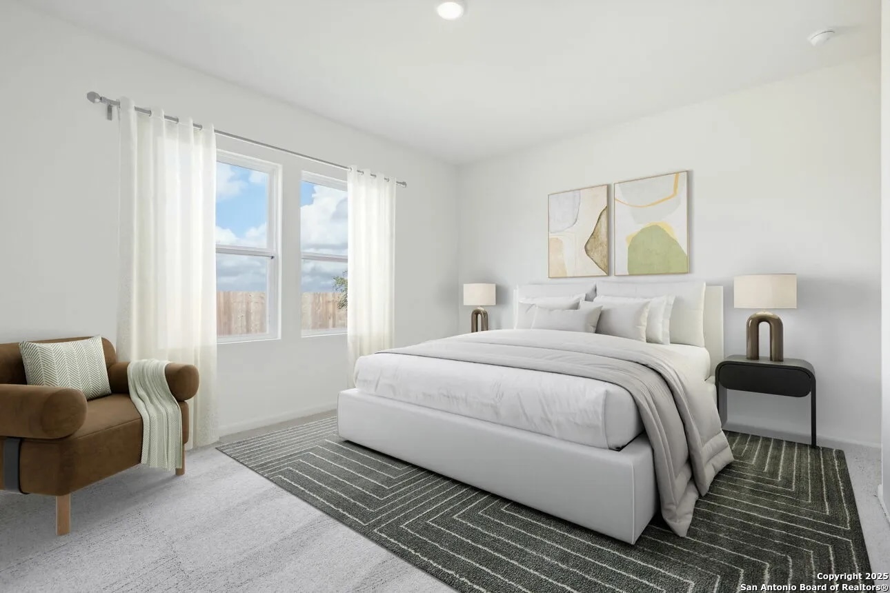 815 Dark Lark Adkins, TX 78101 - Photo 7 of 11 a bedroom with a bed and wooden floor