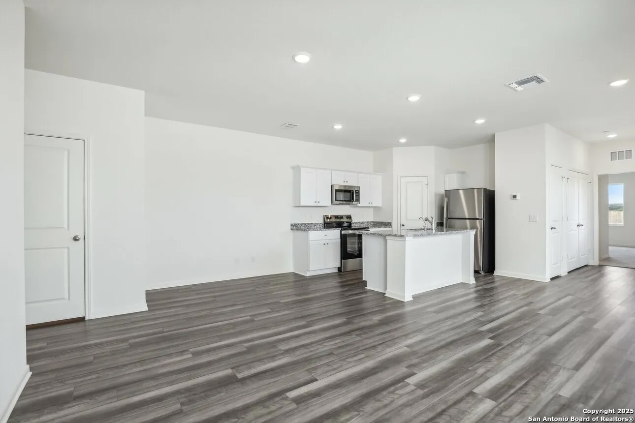 815 Dark Lark Adkins, TX 78101 - Photo 9 of 11 a view of kitchen with wooden floor