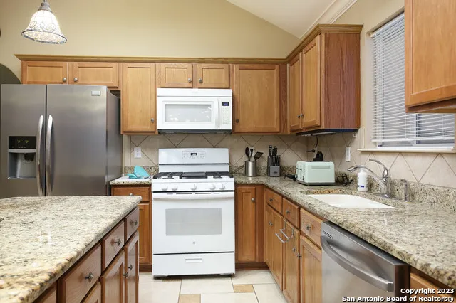 a kitchen with a sink stove and refrigerator