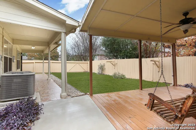a view of a backyard with sitting area