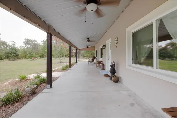 a view of a porch with chairs and backyard