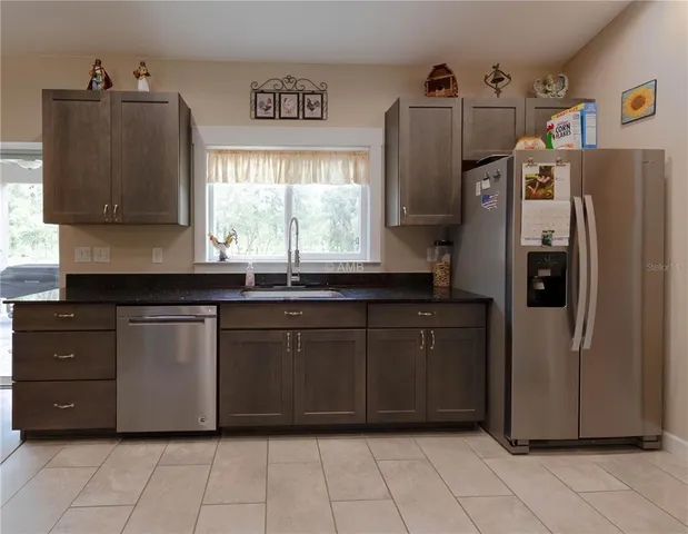 a kitchen with a refrigerator and a sink