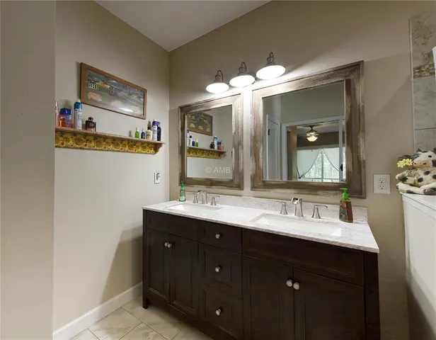 a bathroom with a double vanity sink and a mirror