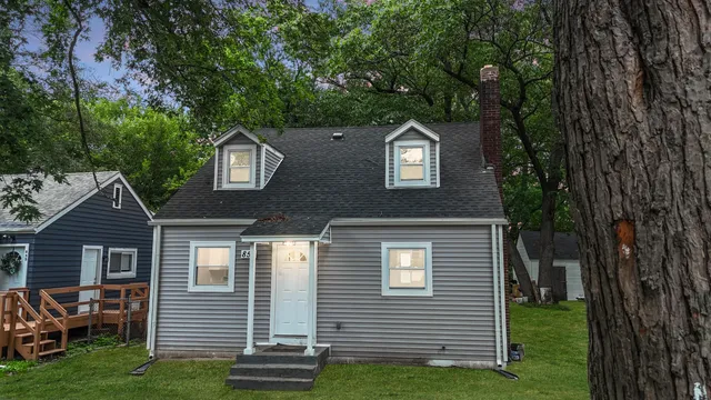 a front view of a house with a garden