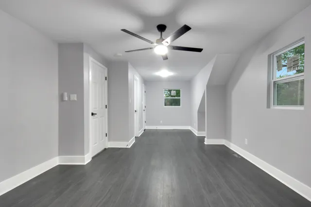 a view of an empty room with wooden floor