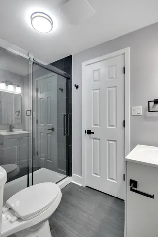 a bathroom with a shower a sink and a mirror