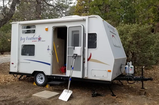 a view of a small house with a car parked in front of it
