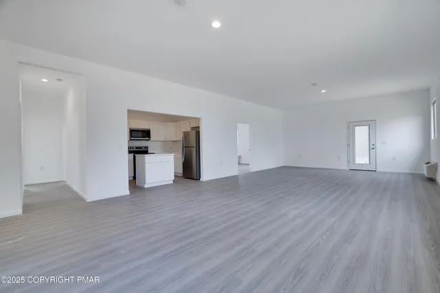 a view of a kitchen with a sink and a stove top oven