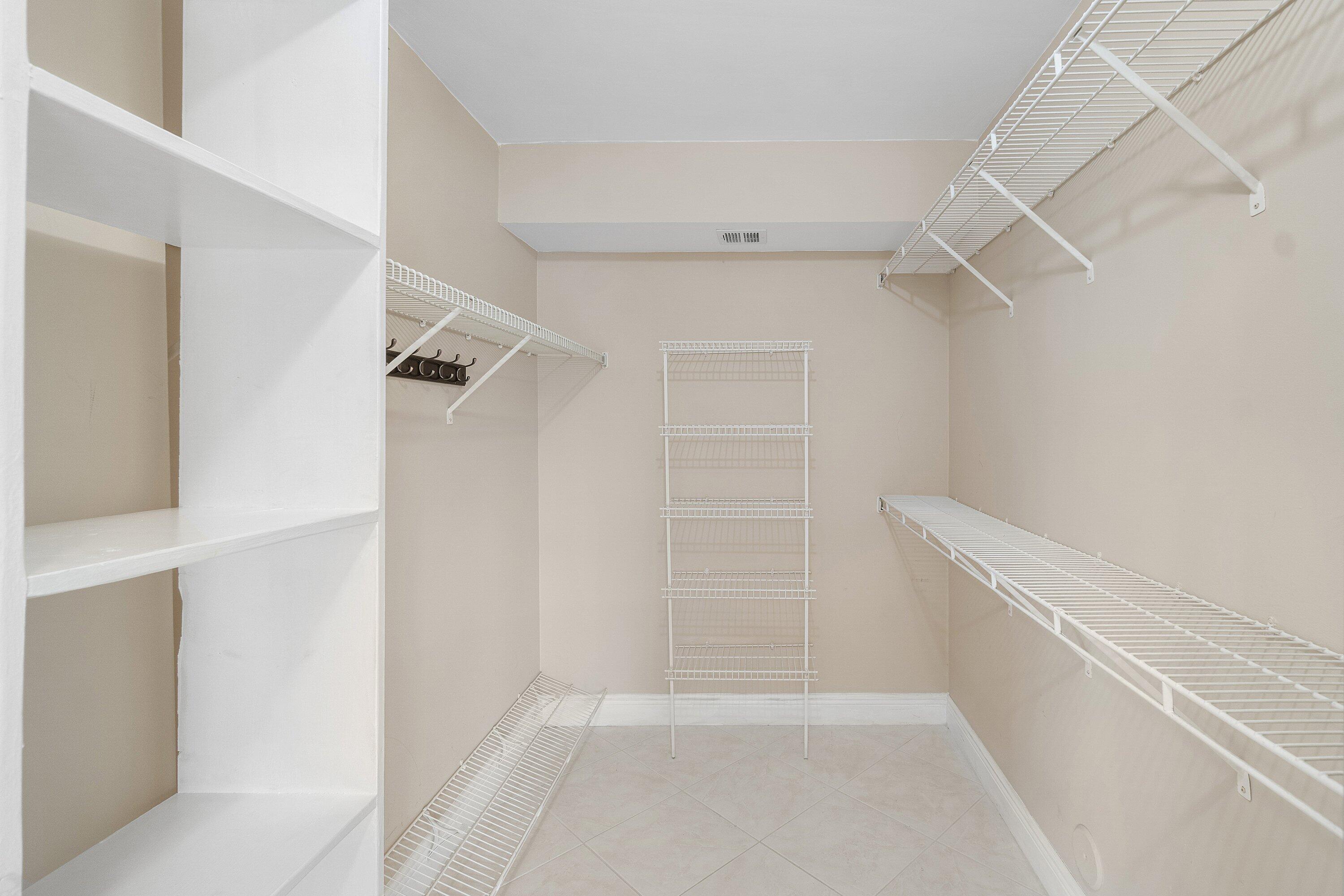 14096 Huntington Pointe Drive, Unit 106 Delray Beach, FL 33484 - Photo 34 of 47 a view of walk in closet with empty racks
