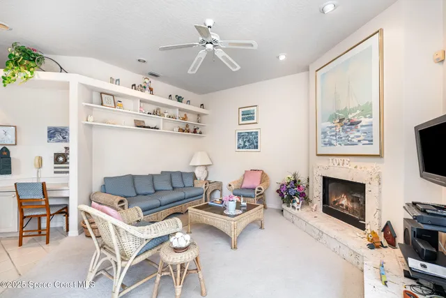 a living room with furniture fireplace and a large window