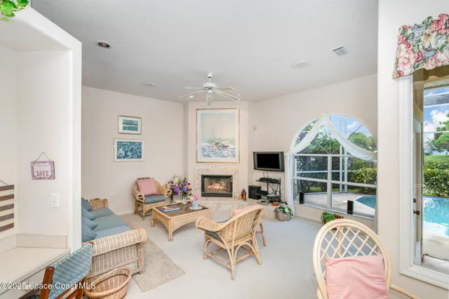 a view of a porch with a table and chairs and potted plants