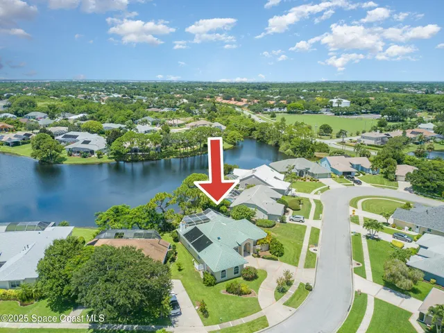 an aerial view of residential houses with outdoor space and swimming pool