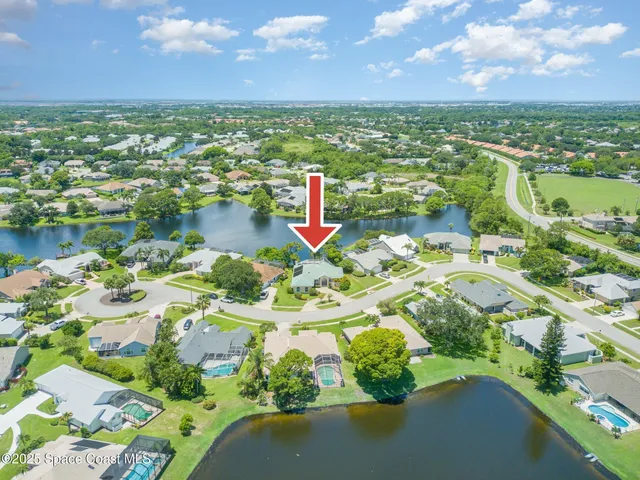 an aerial view of a house with a lake view