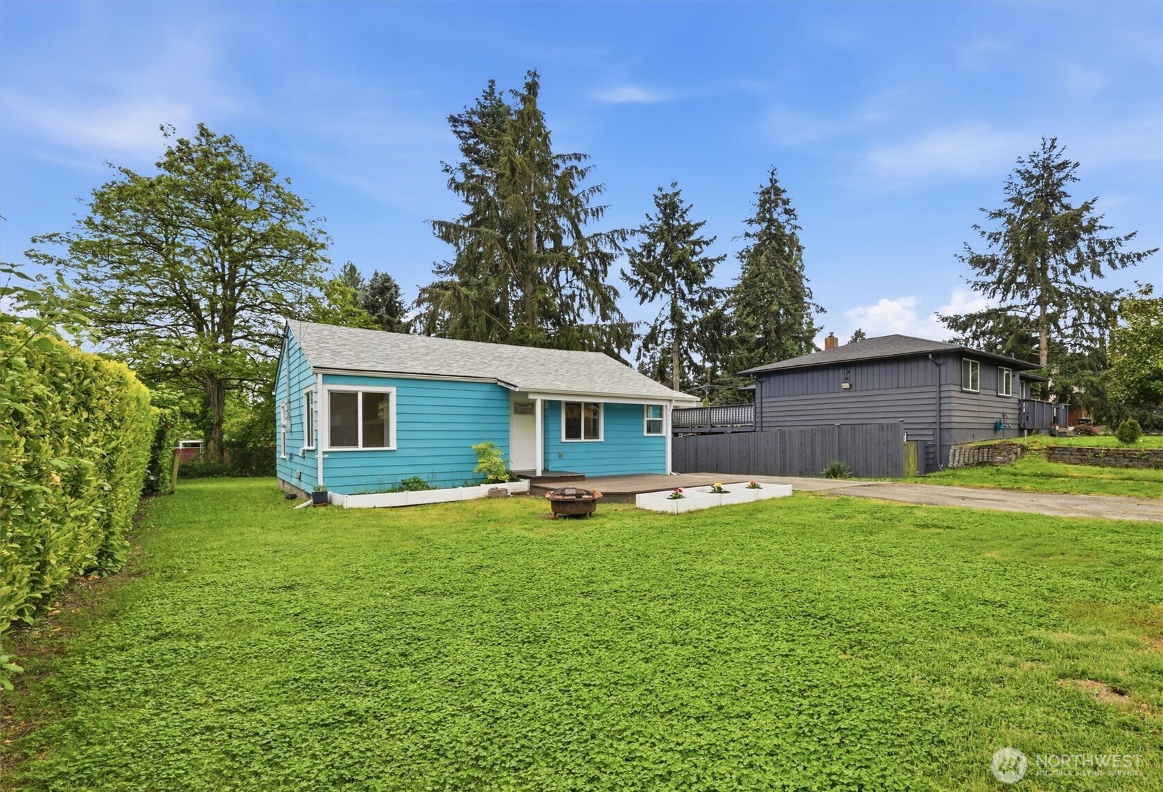 1651 Southwest 114th Street Seattle, WA 98146 - Photo 4 of 37 a big house with a big yard and large trees