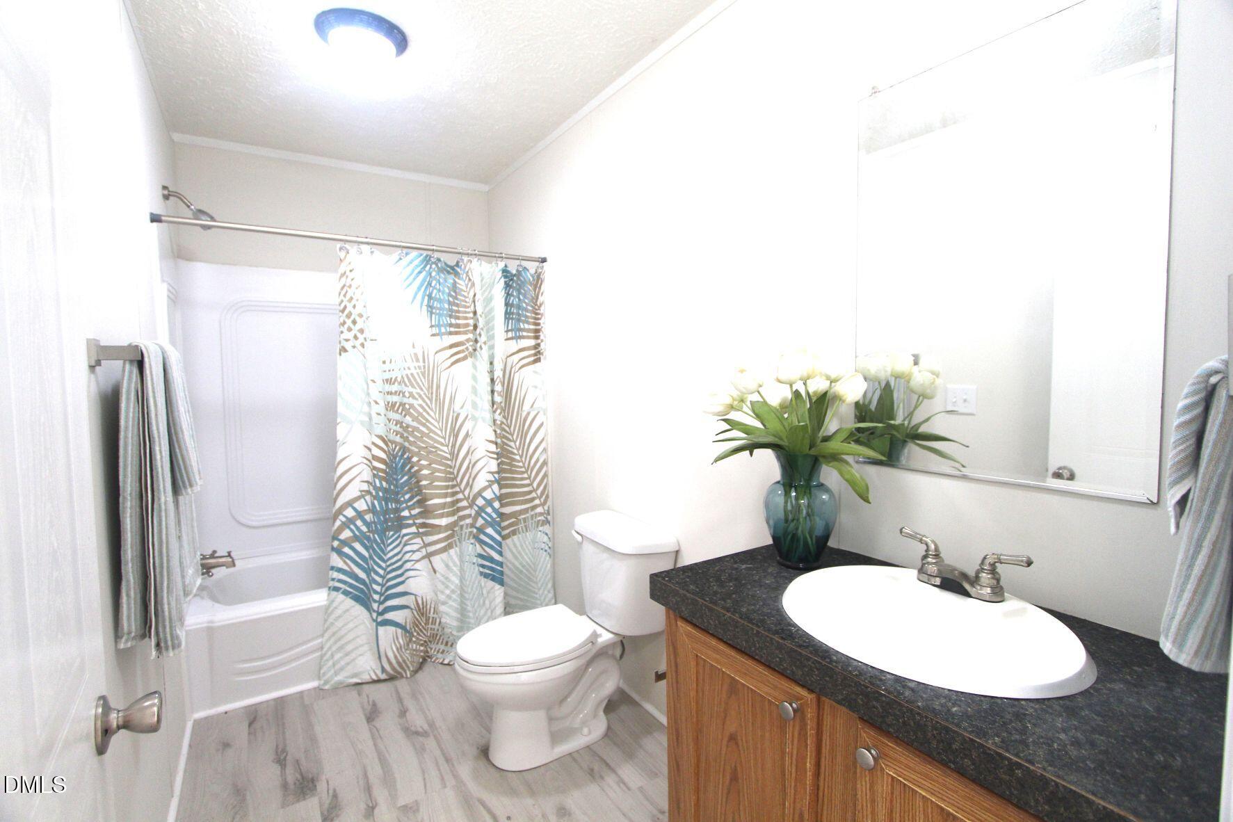 721 General Green Road Kittrell, NC 27544 - Photo 25 of 36 a bathroom with a granite countertop sink toilet and shower