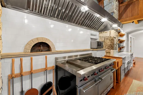 a stove top oven sitting inside of a kitchen