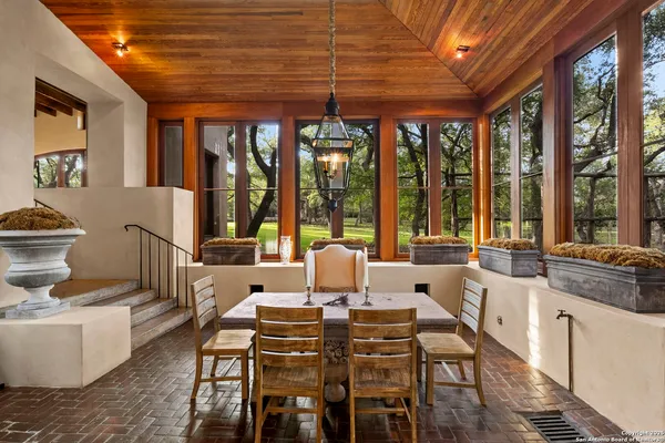 a living room with furniture and large windows