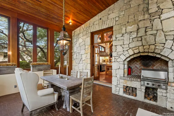 a dining room with furniture a fireplace and wooden floor