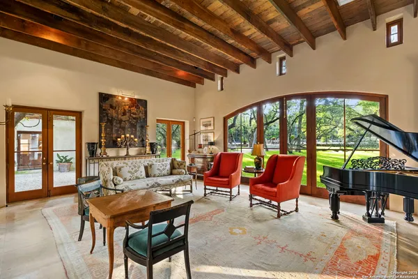 a living room with furniture a table and chairs next to a window