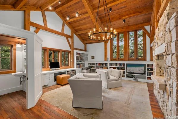 a living room with furniture and a chandelier