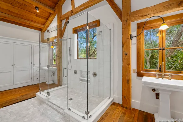 a bathroom with a shower and a sink