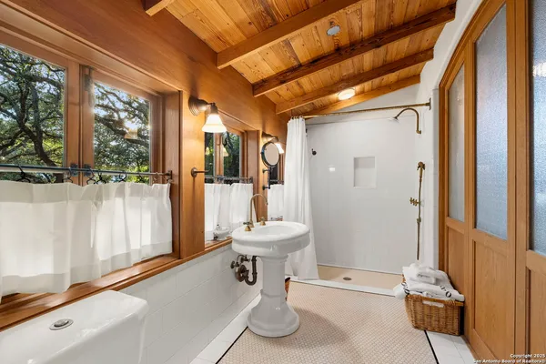a bathroom with a toilet a sink and shower