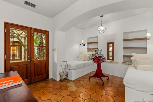 a living room with furniture a chandelier and large window