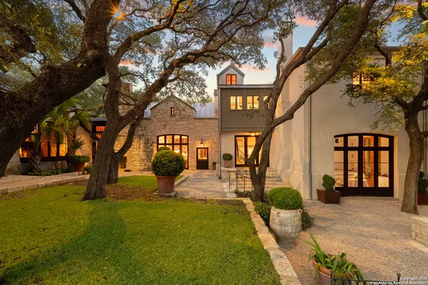 a row of palm trees in front of house