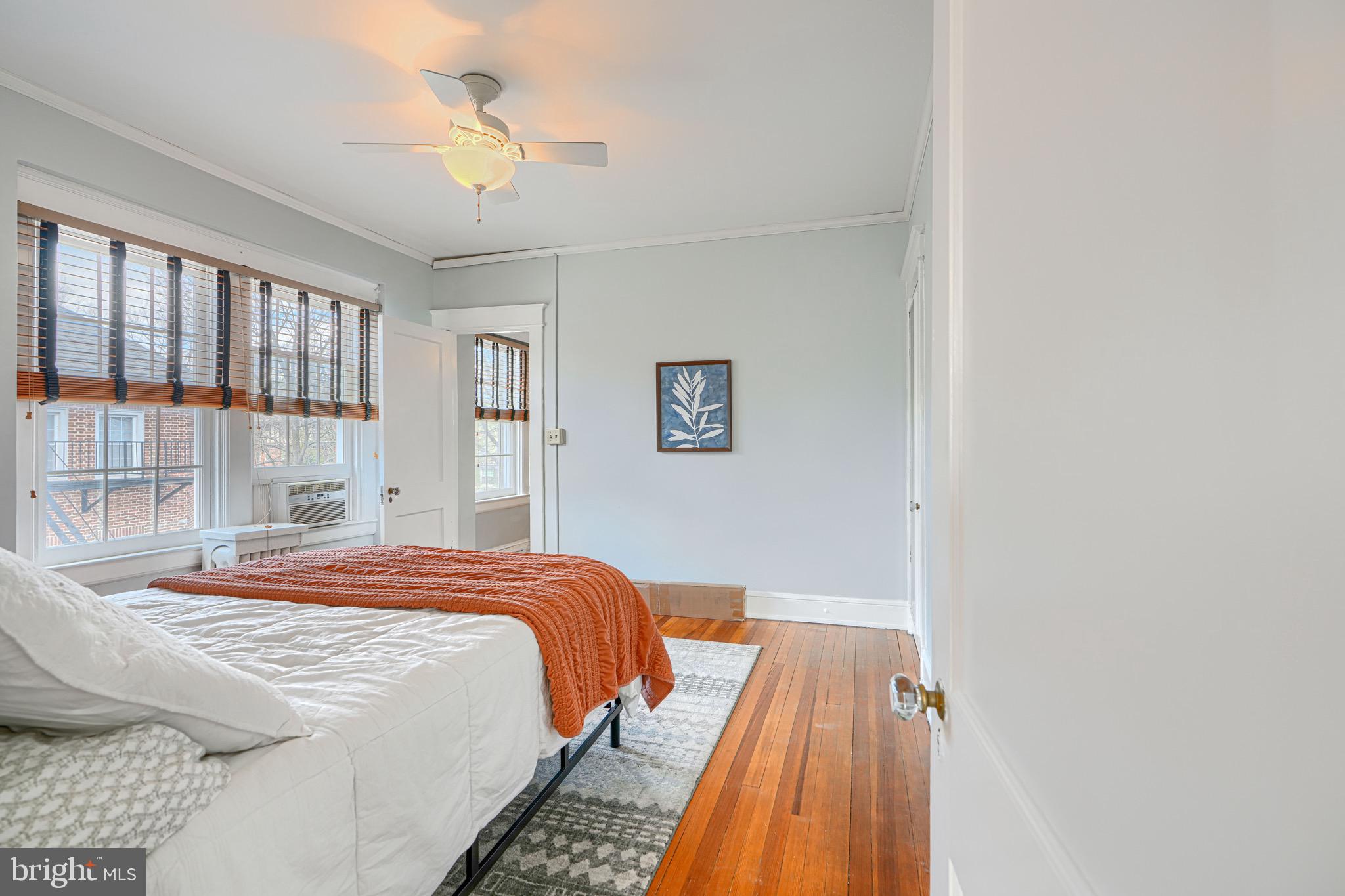 607 Somerset Road, Unit 5 Baltimore, MD 21210 - Photo 21 of 38 a bedroom with a bed and a chandelier