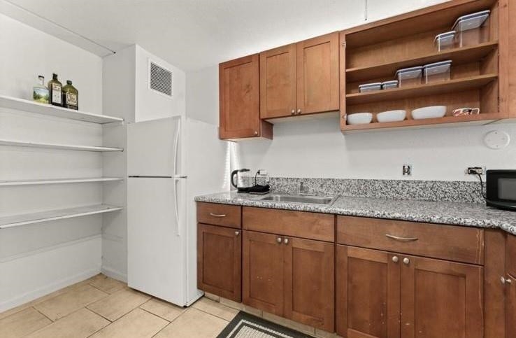 111 Kahului Beach Road, Unit B112 Kahului, HI 96732 - Photo 2 of 15 a kitchen with stainless steel appliances granite countertop a sink and cabinets