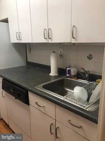 a kitchen with a sink and cabinets