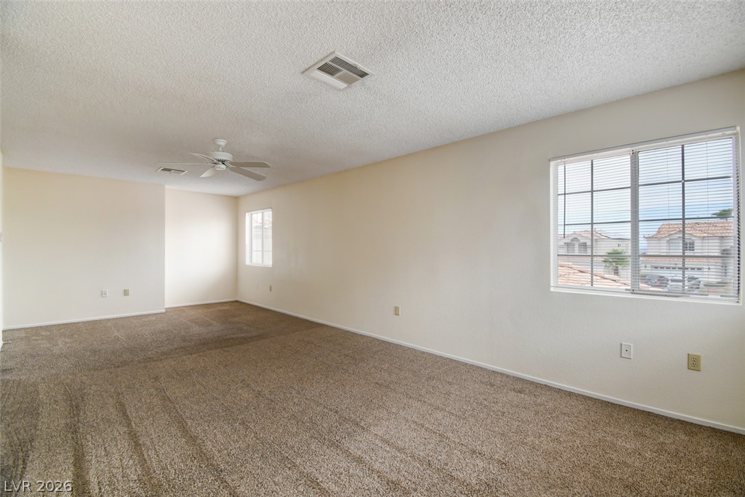 5 Tarryall Terrace Henderson, NV 89074 - Photo 35 of 44 A spacious room featuring abundant natural light and soft, neutral carpeting.