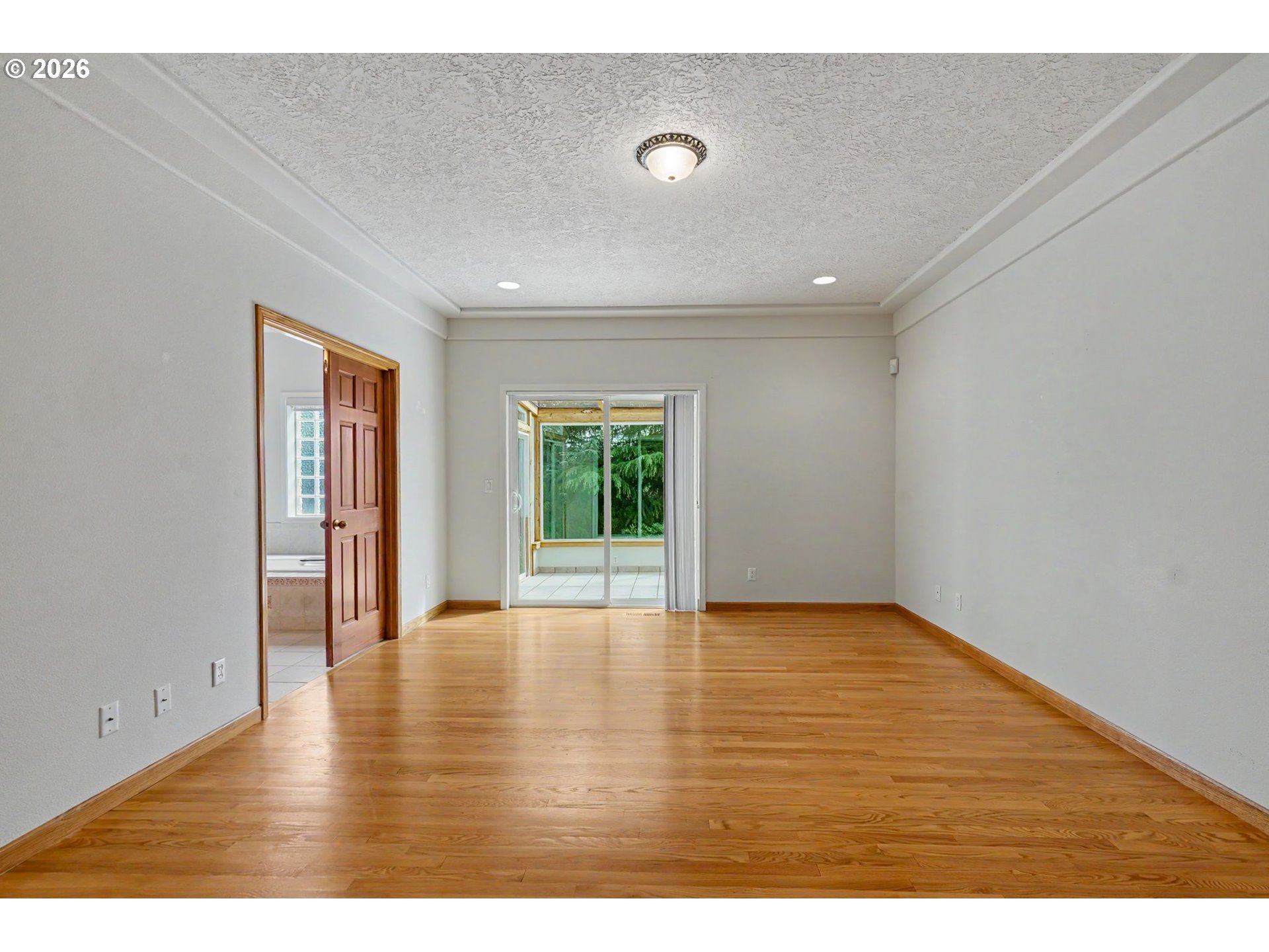 1470 Ranier Loop Northwest Salem, OR 97304 - Photo 29 of 48 a view of an empty room with wooden floor and a window