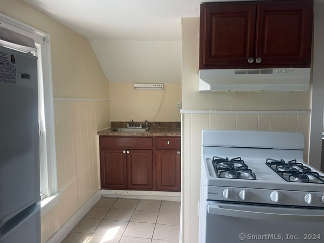 24 Arthur Street New Haven, CT 06519 - Photo 6 of 14 a kitchen with a stove and a cabinet
