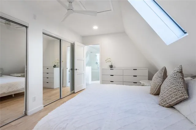 a spacious bedroom with a bed and a walk in closet