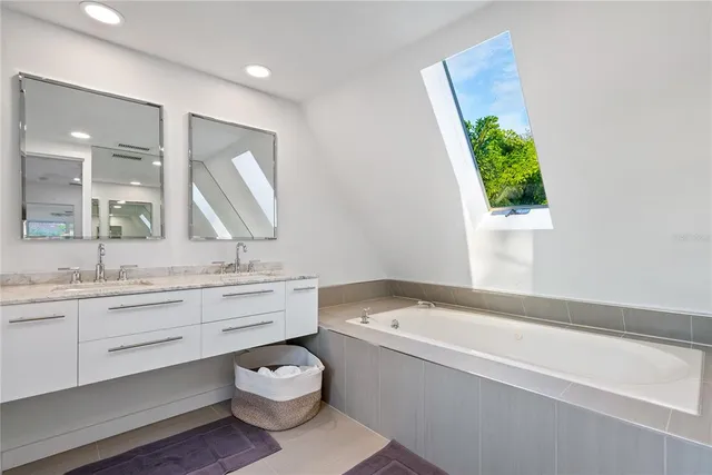 a bathroom with a granite countertop toilet a sink and a large mirror