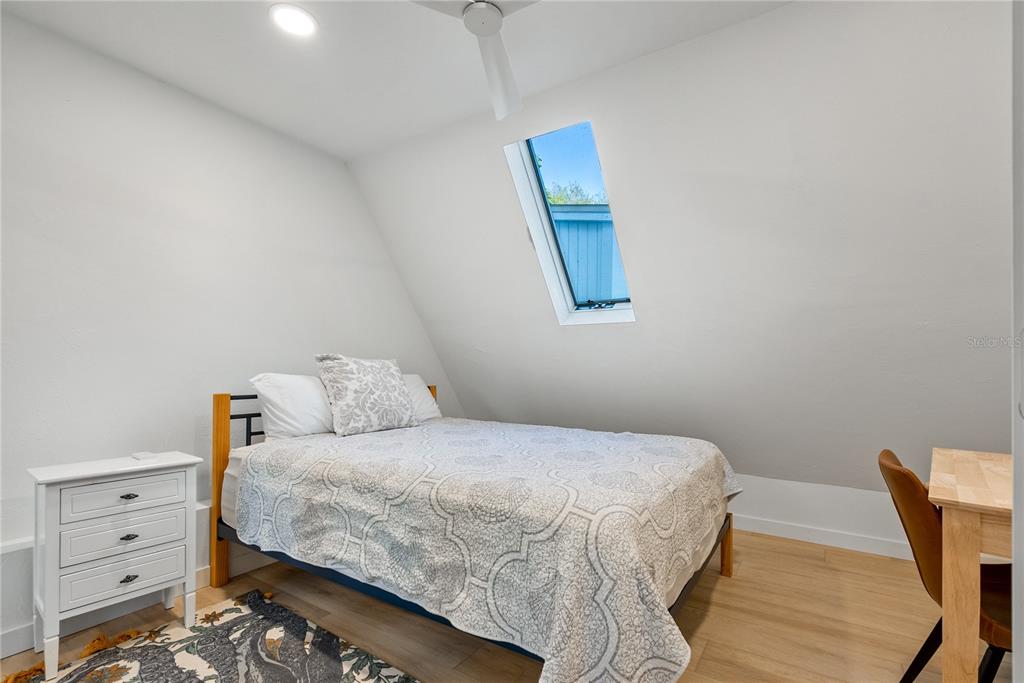 1909 High Point Drive Sarasota, FL 34236 - Photo 17 of 26 a bedroom with a bed and a chair