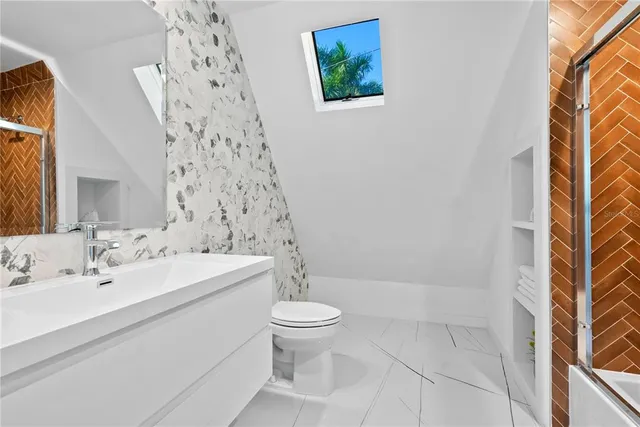 a bathroom with a sink a toilet and shower curtain