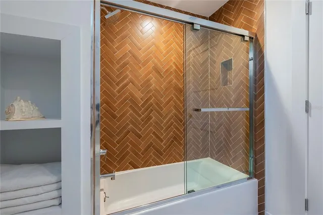 a bathroom with a bathtub and shower