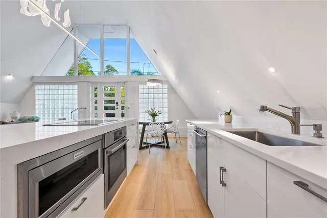 a kitchen with a sink a window and stainless steel appliances
