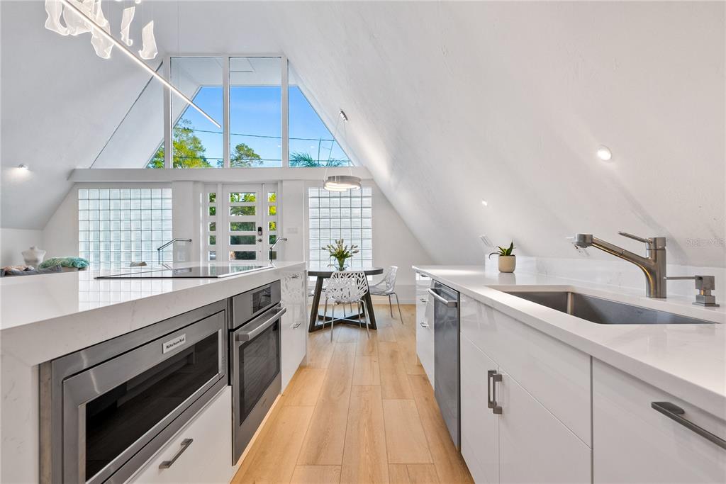 1909 High Point Drive Sarasota, FL 34236 - Photo 8 of 26 a kitchen with a sink a window and stainless steel appliances